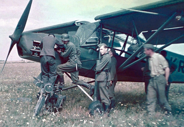 German ground crew working on a biplane aircraft in a field