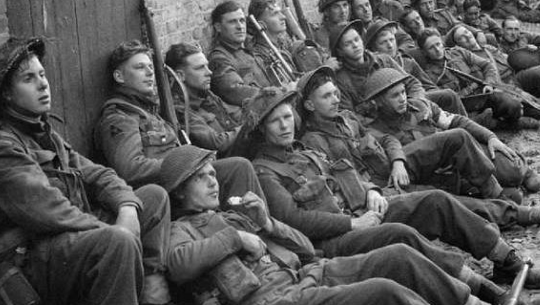 British prisoners of war resting against a wall