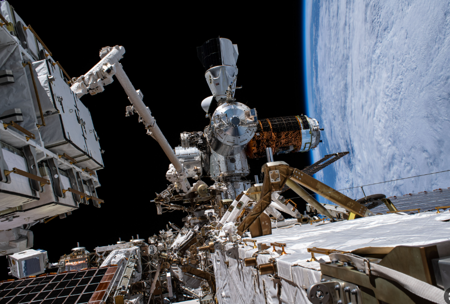 Space station exterior with Earth in background — The Last Cargo